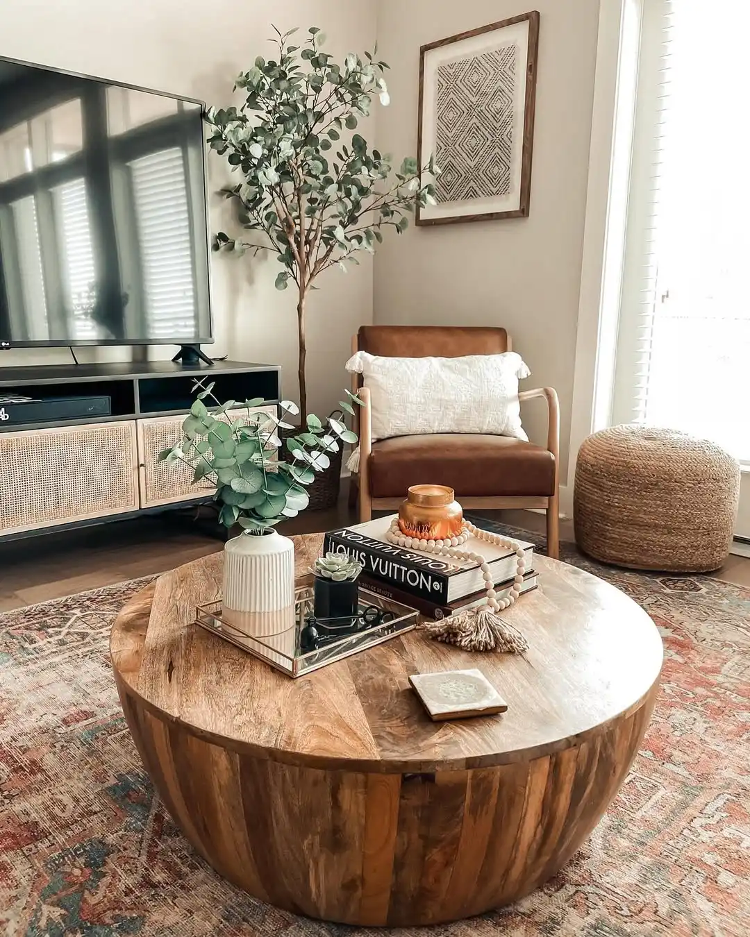 15 Small Living Room Decor Ideas That Feel Luxurious on a Budget 3 2. Style a Round Wood Coffee Table as a Focal Point