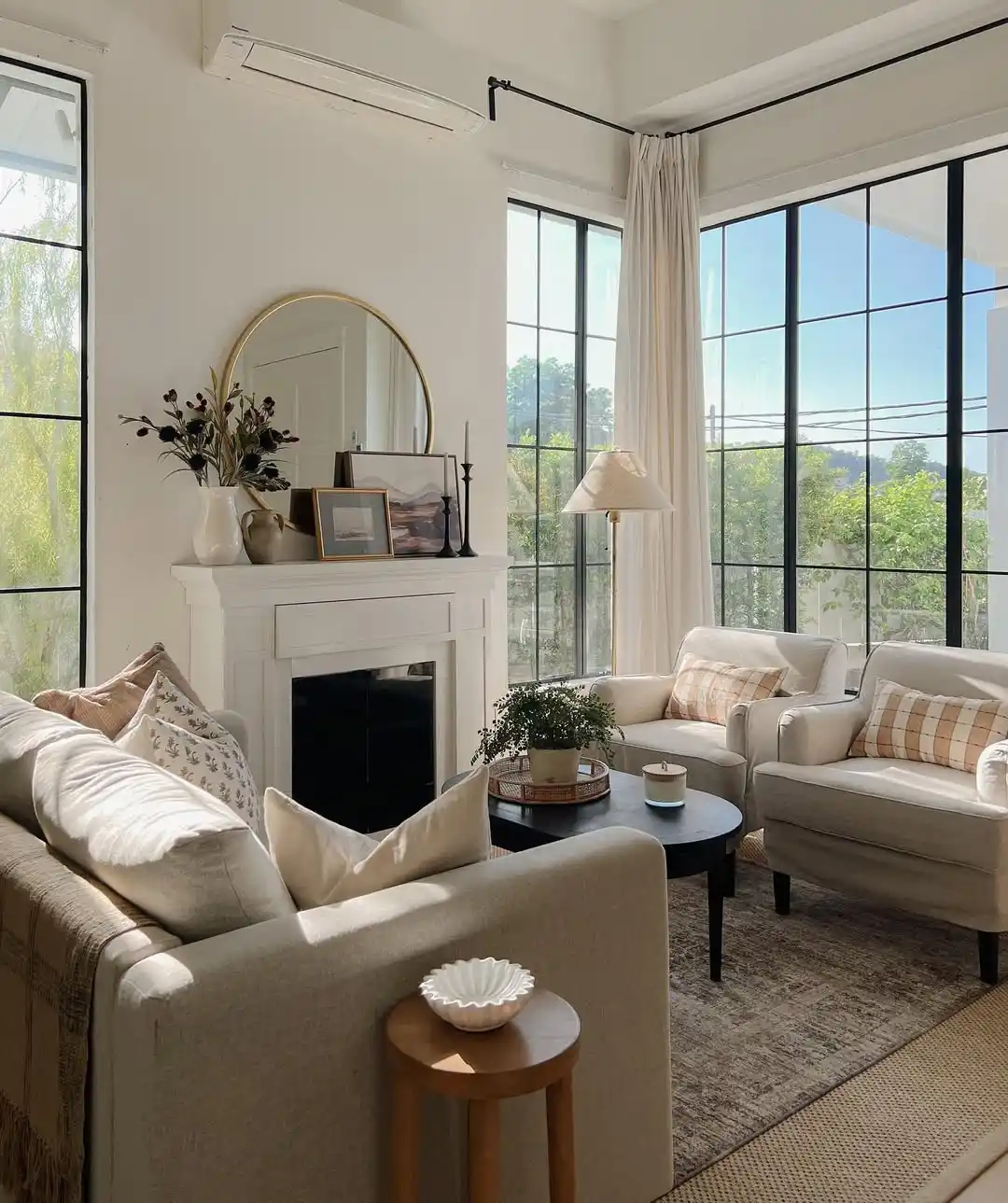 15 Small Living Room Decor Ideas That Feel Luxurious on a Budget 5 4. Hang a Round Mirror Above the Fireplace Mantel
