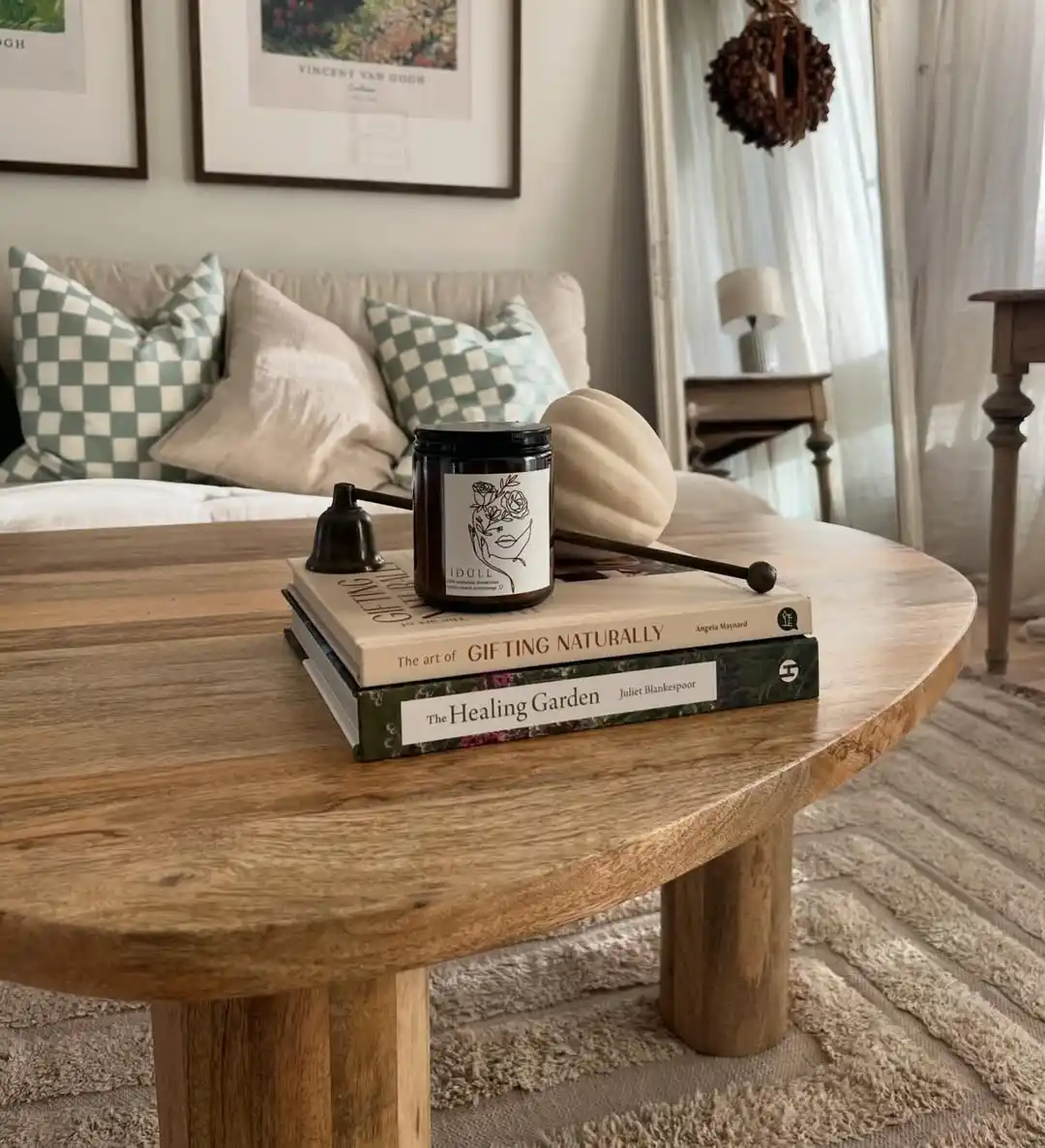 15 Small Living Room Decor Ideas That Feel Luxurious on a Budget 10 9. Style Your Coffee Table With Stacked Books and a Candle