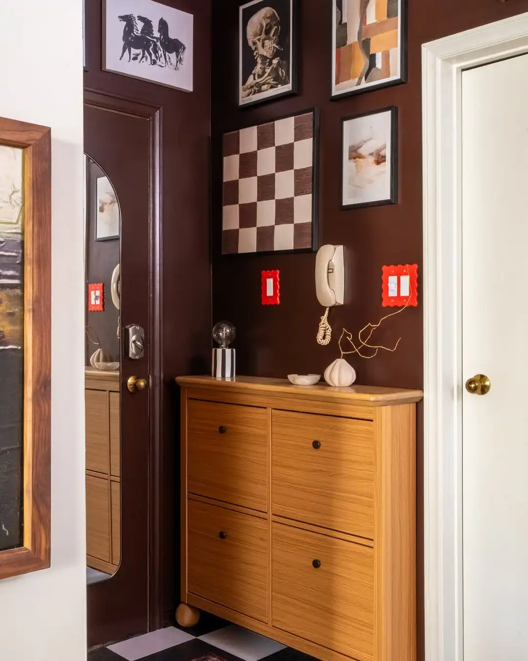 9. Deep Chocolate Walls Let a Bold Gallery Wall and Warm Wood Cabinet Take Over