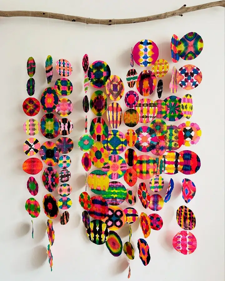Tie Dye Paper Circles Hanging from a Branch